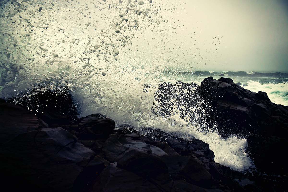 transportation grayscale photography of ocean waves crashing on rock during daytime vehicle
